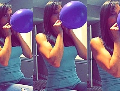 Lexi Luna blowing a balloon in the bathroom