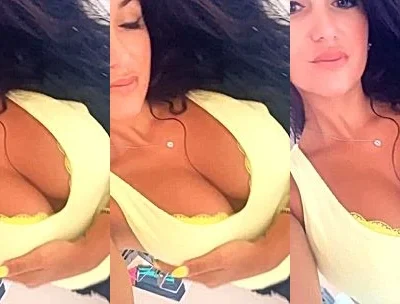 Angela doll teasing her deep cleavage in her yellow top