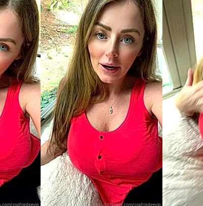 Sophie Dee showing off her big tits on the couch
