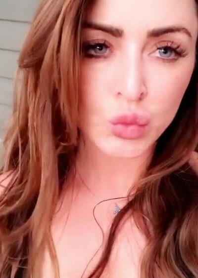 Sophie Dee flashing her naked big tits in her backyard