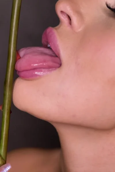 Melissa Stratton seductively licking a thorned rose