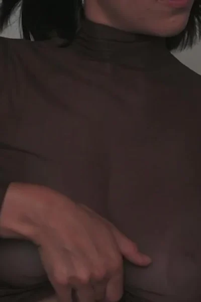 Tania Bann playing with her big tits in her black see-through crop-top