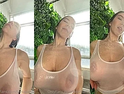 Tania Bann teasing her wet big tits in her white see-through top