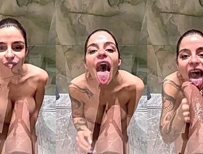 horny babe Sonya Jess sucking on a big wall dildo in the shower