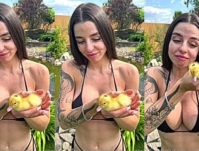 Sonya Jess playing with a tiny duckling in her black bikini