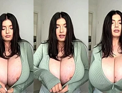 Busty Ema playing with her big tits in green sweater