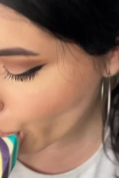 Busty Ema sucking on a lollipop and dildo